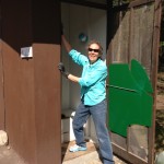 Suzanne cleaning the men's outhouse