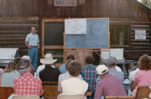 Bob Dunkley explains Park plans for the Polebridge Ranger Station, post Red Bench Fire, at the 1989 Interlocal at Sondreson Hall.