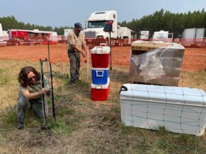 Montana FWP and Flathead National Forest staff install electric fence around possible bear attractants at the Hay Creek Fire Camp on August 4, 2021