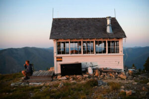 Leif Haugen with his morning coffee at the Thoma lookout post in the Flathead National Forest, Mont - NYT photo